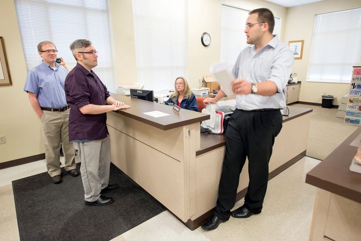 David Ermold (left) and his husband, David Moore (center), were among the couples who were denied marriage licenses by Kim Davis in 2015.