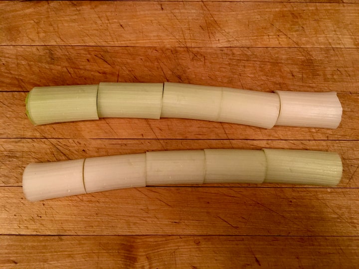 <p>A leek, halved lenthwise, cut crosswise, and ready to be julienned</p>