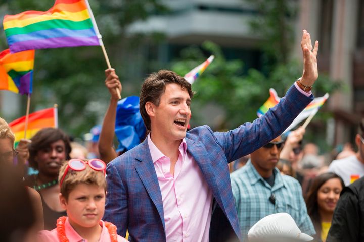 Prime Minister Justin Trudeau waves to the crowd as he marches in the Pride Parade in Toronto in June.