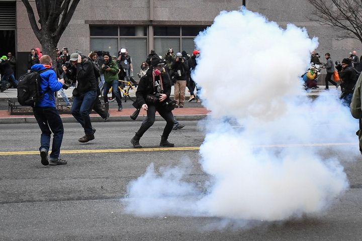 Protesters and journalists scramble as stun grenades are deployed by police during a protest in Washington on Inauguration Day.