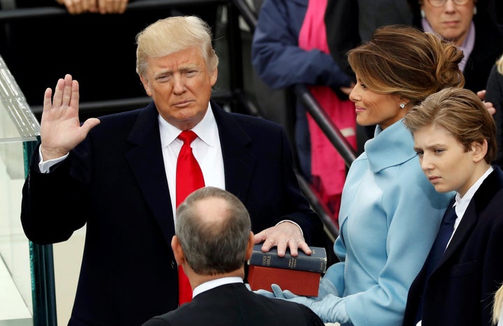 U.S. President Donald Trump takes the oath of office on Jan. 20, as protesters demonstrated in downtown Washington.