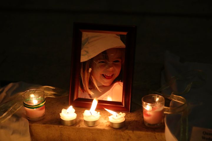 Candles light a photograph of Madeleine McCann outside a church in Praia da Luz on the tenth anniversary of her disappearance in May 