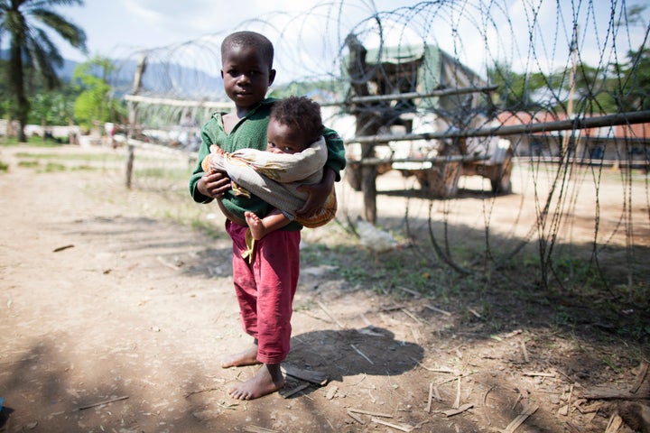 A child in Bunyampuli, in the North Kivu province of the Democratic Republic of the Congo, seeks refuge near a UN camp after heavy fighting between Government forces and the Mai-Mai Cheka militia group. 