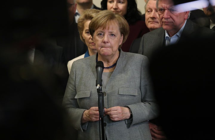 German Chancellor and leader of the German Christian Democrats (CDU) Angela Merkel, standing with leading members of her party, speaks to the media in the early hours after preliminary coalition talks collapsed following the withdrawal of the Free Democratic Party (FDP) on November 20, 2017 in Berlin, Germany. (Photo by Sean Gallup/Getty Images)