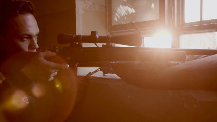 A sniper on lookout in a school in West Mosul