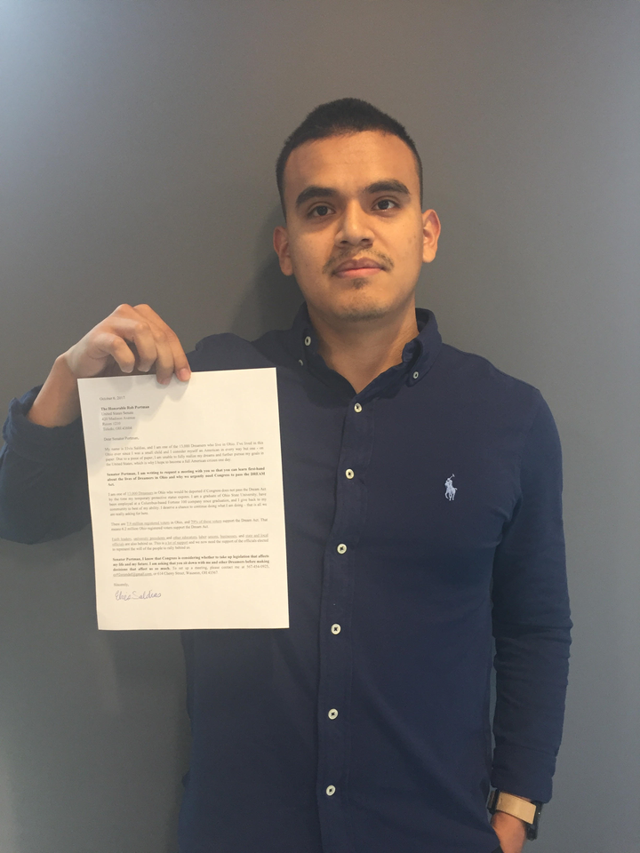 Elvis Saldias stands with a letter addressed to Senator Rob Portman requesting clarity on his DACA stance as well as his view