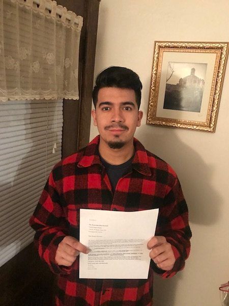 Ariel Lopez stands with a letter addressed to Senator Rob Portman requesting clarity on his DACA stance as well as his views concerning the over 13,000 Dreamers in Ohio.