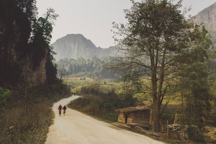 Rebecca Rusch and her riding partner, Huyen Nguyen, pedal the Ho Chi Minh trail in Laos on February 26, 2015