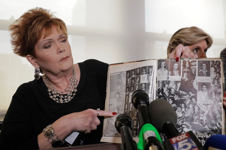 Beverly Young Nelson points to a photograph of herself in her high school yearbook after claiming that Moore sexually harassed her when she was 16. She made the allegation at a press conference in New York on Nov. 13.