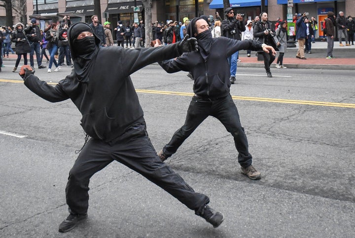 Protesters throw rocks at police during a protest near the inauguration of President Donald Trump in Washington, D.C., Jan. 20, 2017.