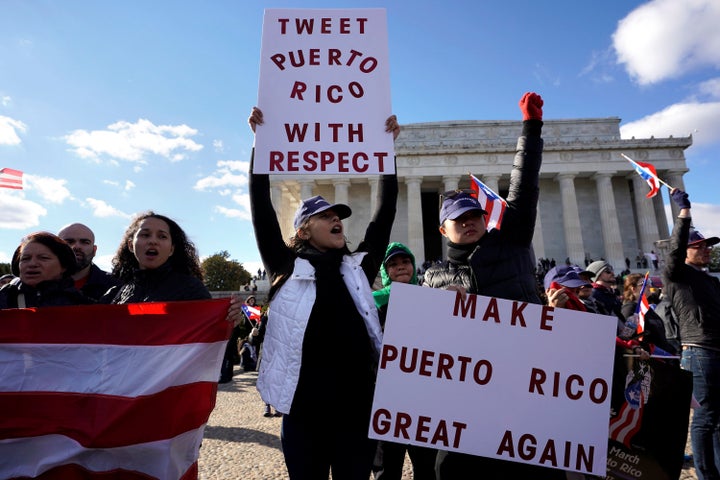 Protesters in front of the Lincoln Memorial on Sunday call on Congress to send more aid to Puerto Rico.