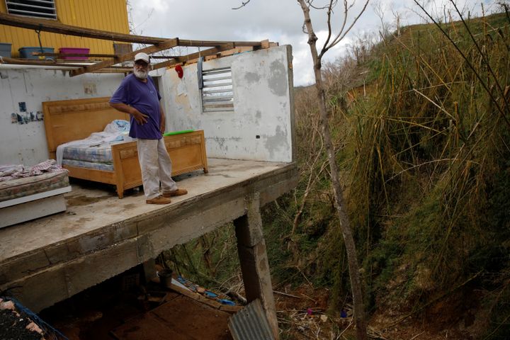 On Oct. 11, 2017, Roberto Morales Santos, 70, looks out from his damaged San Juan home.