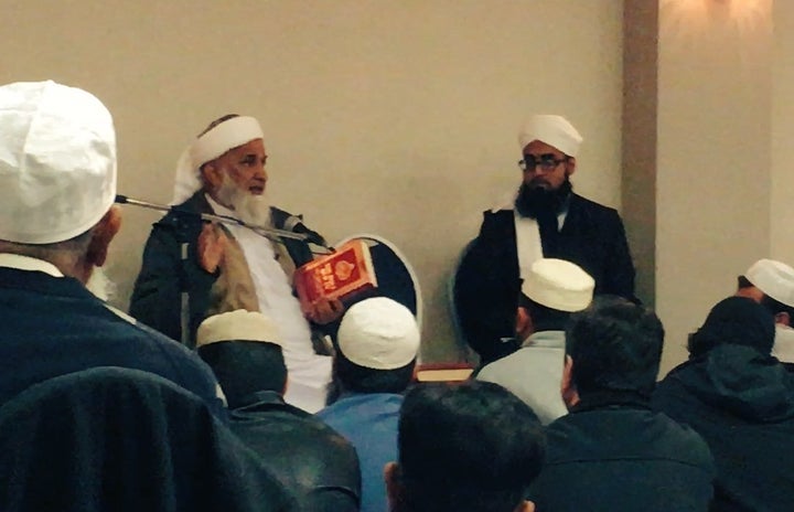 Maulana Rafiq Khan, one of the event organizers, holding a copy of the Quran that he wants removed from American libraries. 