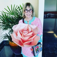 I’m holding a flower during my recent travels to Bhutan. 