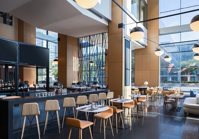 <p>Woven & bound restaurant at the Marriott Marquis Chicago featuring USB ports and outlets at bar seating.</p>