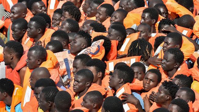 <em>African refugees on a rubber boat wait to be evacuated during a rescue operation by the crew of a rescue ship on November