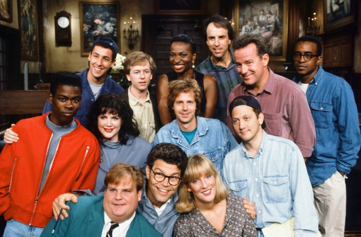 Al Franken is seen among SNL's Season 18 cast members in 1992. The women include Melanie Hutshell, seen in the bottom row to his left, Julia Sweeney, and Ellen Cleghorne.