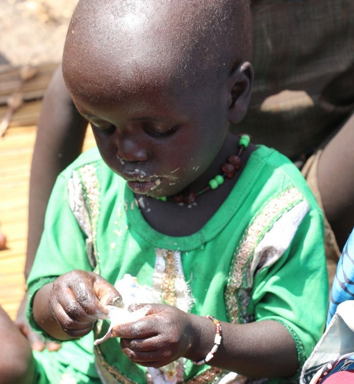 Two-year old Nyantaba Gakier eats nutritious food provided by humanitarian partners in Thonyor. Small children in South Sudan need food to prevent deadly malnutrition. 