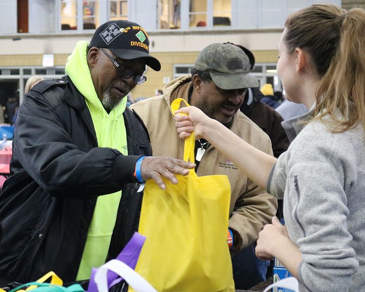 A veteran receives a bag of take-away food, including produce and shelf-stable items, at the veteran Stand Down in Chicago on Friday, November 17, 2017.