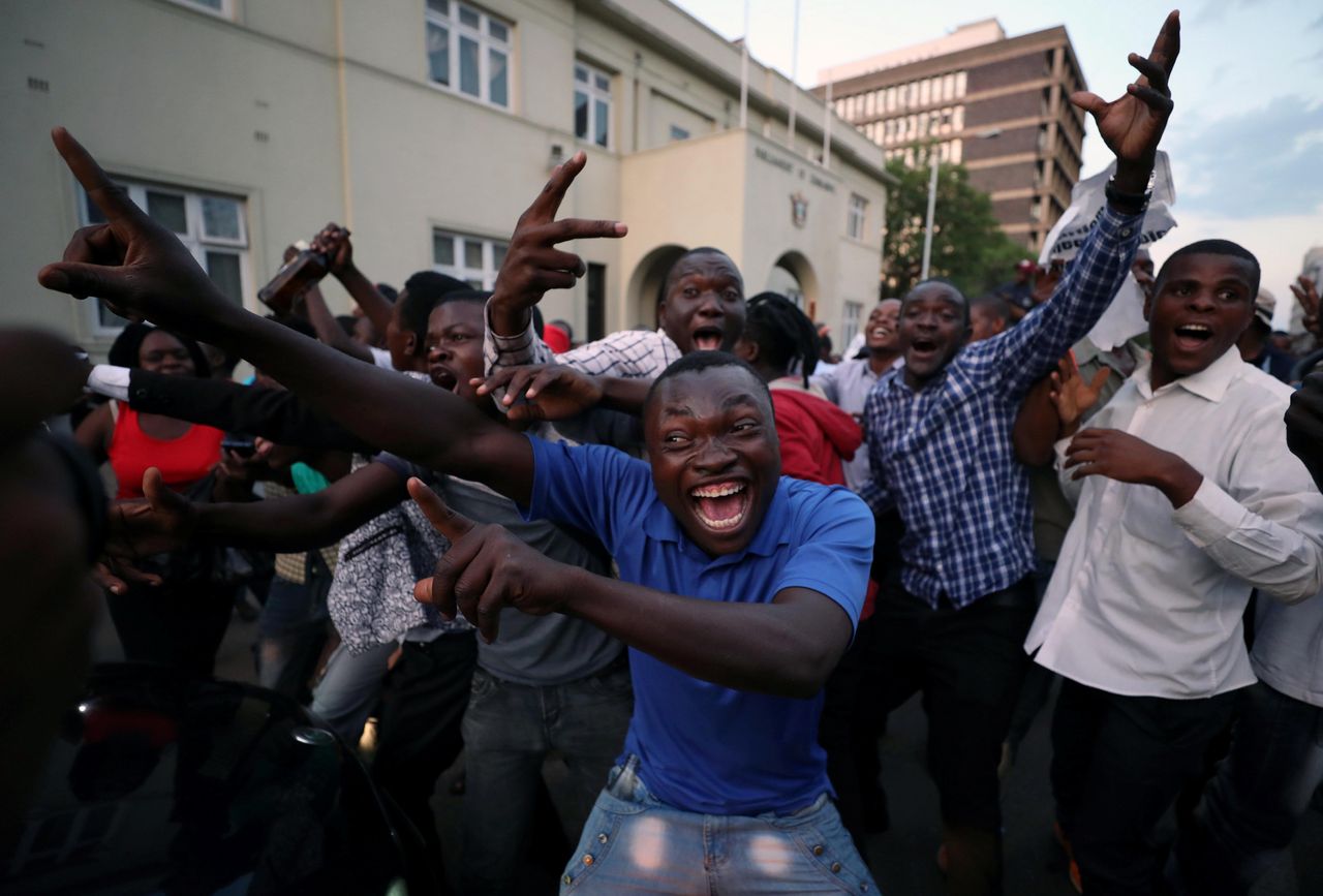 Zimbabweans celebrate in the capital city of Harare after President Robert Mugabe resigned on Nov. 21.