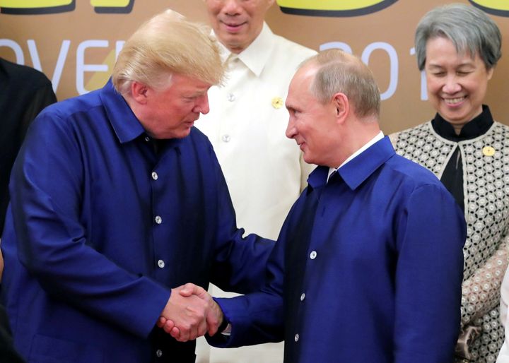 Donald Trump and Vladimir Putin shake hands at a summit in Vietnam on Nov. 10.