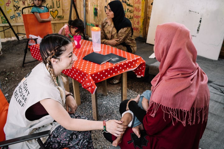 Lighthouse Relief staff bond with a mother, in the Female Friendly Space of the Ritsona Refugee Camp 