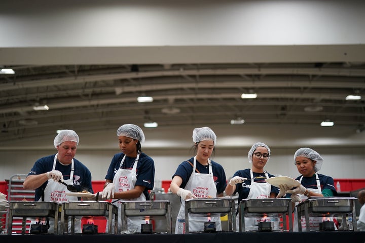 Volunteers with Capital One help plate Thanksgiving dinner for more than 5,000 District of Columbia residents during Salvation Army and Safeway's annual "Feast of Sharing" at the Walter E. Washington Convention Center on Nov. 22.