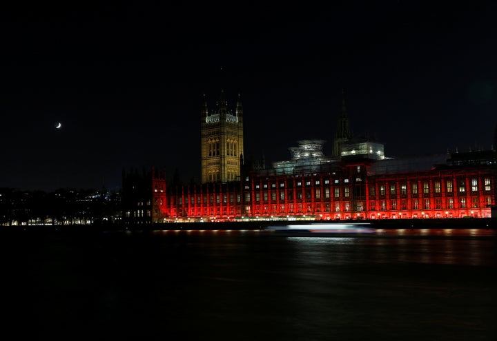 The Houses of Parliament in Westminster are floodlit in red light to mark #RedWednesday on Nov. 22 in London, England.