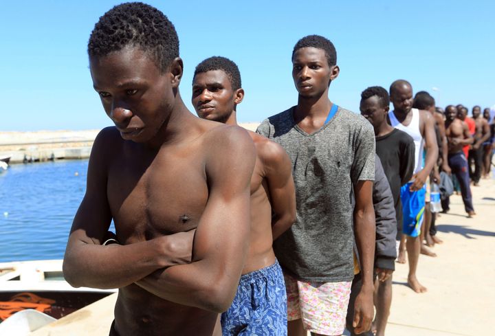 Migrants from Africa who are trying to reach Europe walk toward a detention center off the coastal town of Guarabouli, Libya, on July 8.