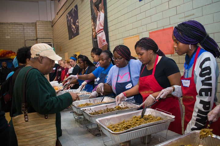 Volunteers serve warm meals at the Food From Heaven Thanksgiving event. 