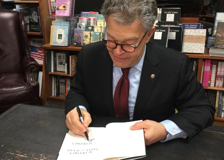All smiles: Senator Al Franken signs my book at an event to promote his memoir Giant in the Senate. Little did I know that less than two months later he would be accused of groping four women.