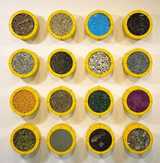 <p>Ashley Bickerton, <em>Terra Firma Nineteen Hundred Eighty Nine #2</em>, 1989, Anodized aluminum, pepper, copper sulfate, pebbles, urban debris, metal shavings, coward, seaweed/skate eggs, cigarettes, raw pigment and broken glass, 88 x 88 x 10 inches, UBS Art Collection</p>