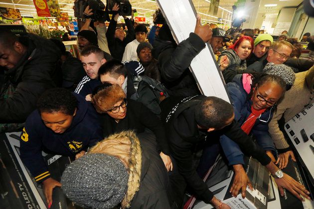 How it used to be: Shoppers fight over Black Friday deals at an Asda store in 2014. 