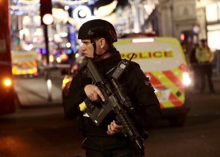 An armed officer standing guard near a cordon during the incident.