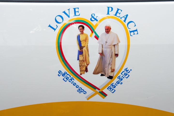 A sticker of Myanmar's State Counselor Aung San Suu Kyi (L) and Pope Franicsis displayed on a car in the streets of downtown Yangon, after the pope's arrival to Myanmar for a four-day official visit, on November 27, 2017. 