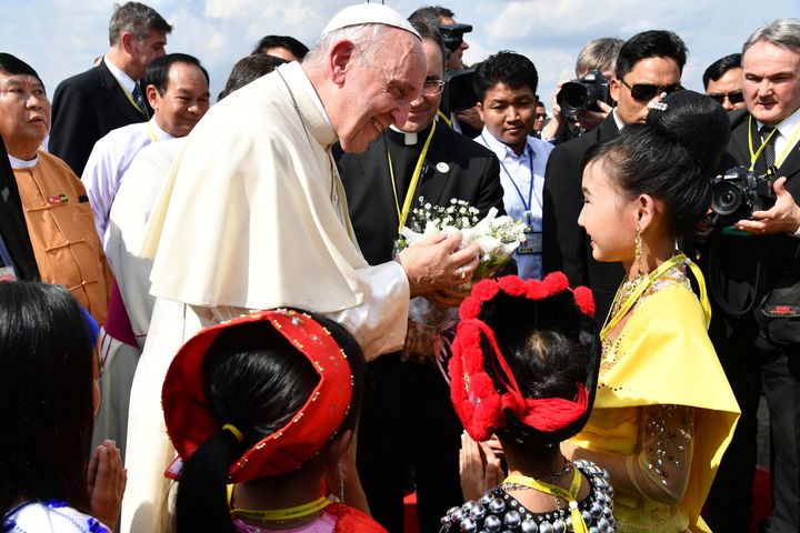 Pope Francis is greeted by children upon his arrival at Yangon International Airport on November 27, 2017. 