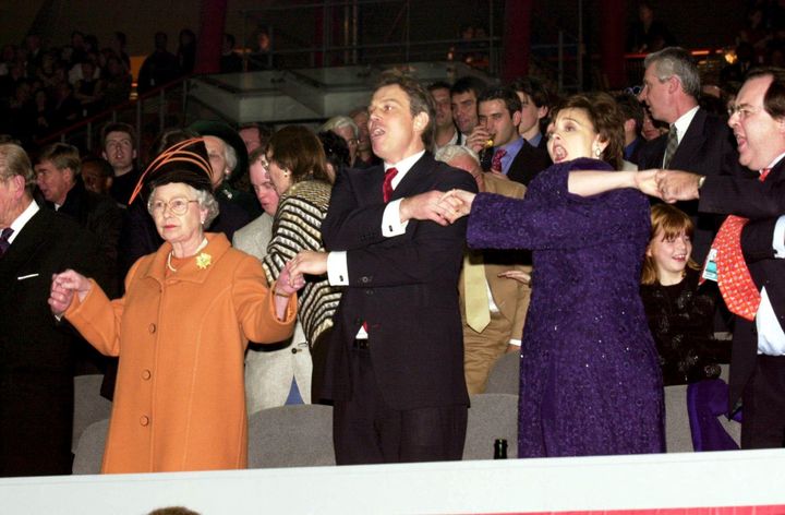 Not amused: Mirth was made when Tony Blair gripped the Queen's hand to sing Auld Lang Syne 