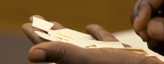 The archbishop of York, Dr. John Sentamu, holds pieces of the clerical collar he cut up in December 2007 to protest Robert Mugabe.