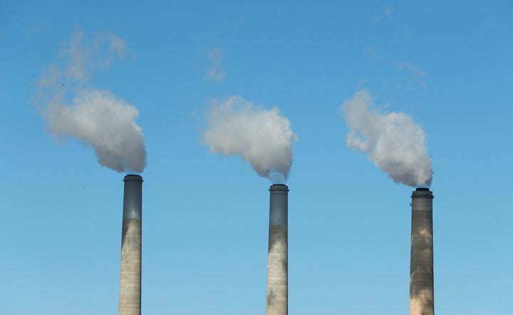 Emissions rise out of three large smokestacks of a coal-fired plant in Utah. A new study suggests the systemic changes scientists say are necessary to avoid the worst effects of warming temperatures will not be done by corporations alone.