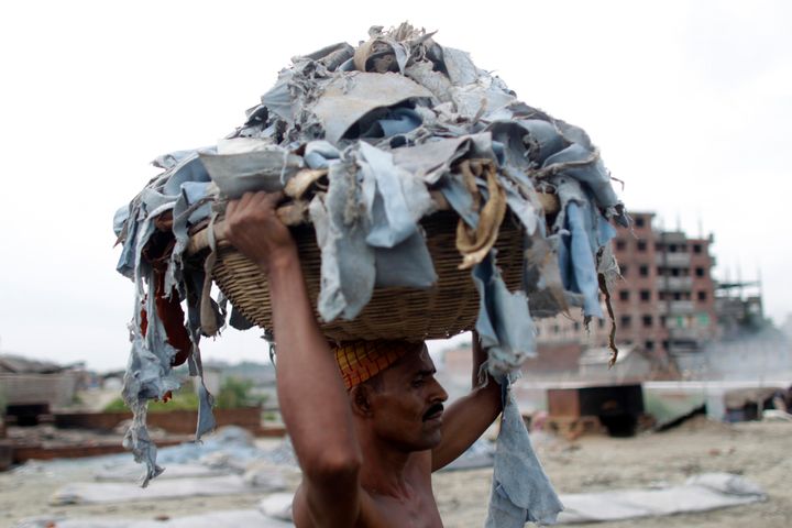 A worker balances a basket of waste products to be processed at a tannery at Hazaribagh in Dhaka, Bangladesh.