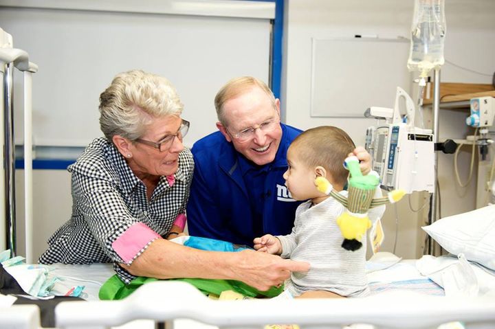 Tom and Judy Coughlin visit with a pediatric cancer patient.