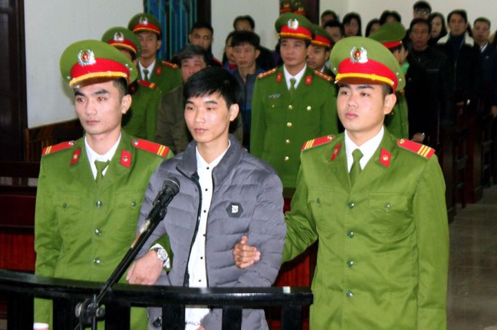 This Nov. 27, 2017, photograph shows activist Nguyen Van Hoa standing trial at a local people's court in the province of Ha Tinh, Vietnam.