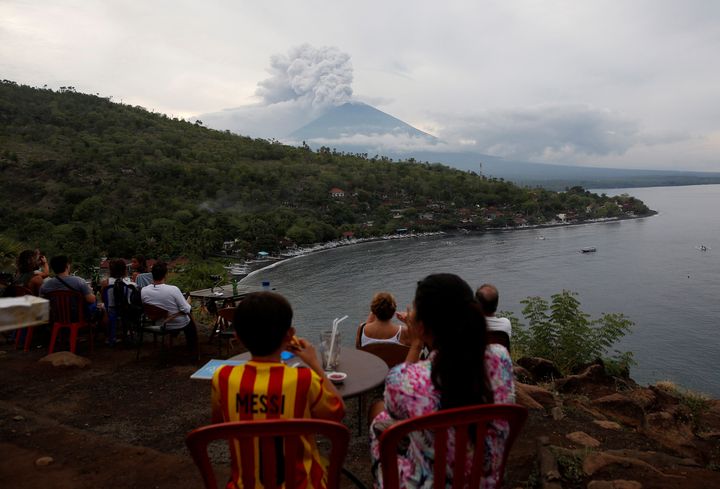 People watch Mount Agung from a cafe near Amed, Karangasem Regency, on Tuesday