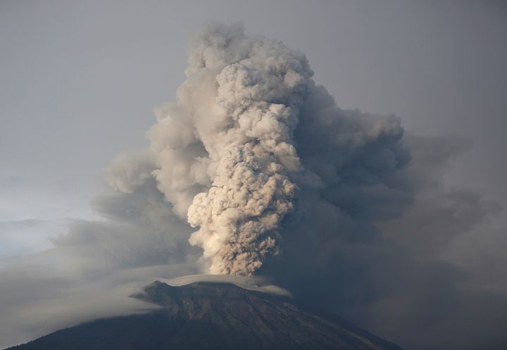 Ash from a volcano swept the island, stranding thousands of tourists; the volcano is pictured above on Tuesday