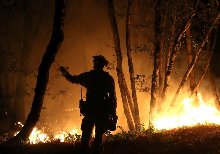 Firefighter Brandon Tolp monitors an operation while battling the Tubbs fire on Oct. 12.