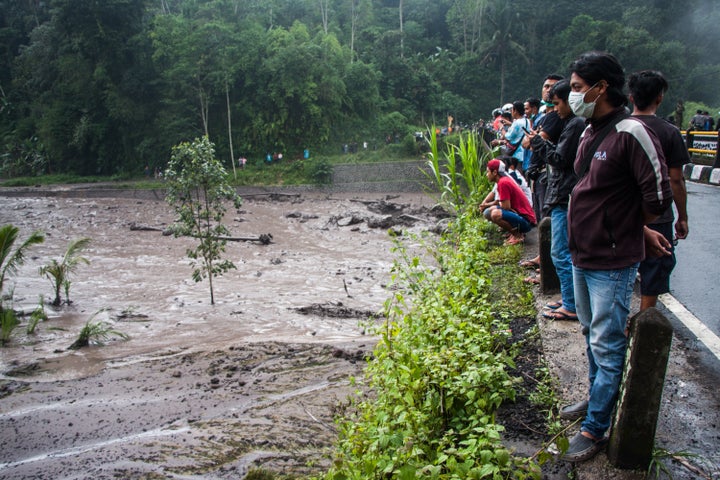 The damage from cold lava flows is worsened by rainfall Tuesday on Bali.