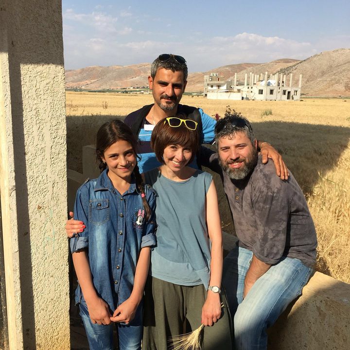 Documentary director/producer Evgeny Afineevsky (seated) in Lebanon’s Beqaa Valley near the Syrian border with Syrian refugee Rahaf Aloush (left) who wrote her will as she and her family approached death from starvation in embattled Madaya Zabadani in 2015. Co-producer Shahida Tulaganova stands center with their driver in the rear.
