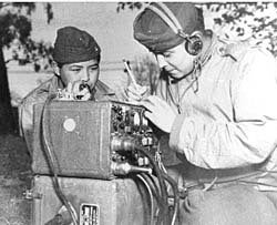 <em>Pfc. Preston Toledo and Pfc. Frank Toledo, Navajo cousins in a Marine artillery regiment in the South Pacific, relay ord