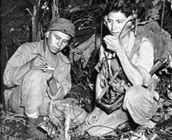 <em>Cpl. Henry Bake, Jr., and Pfc. George H. Kirk, Navajos serving in December 1943 with a Marine Corps signal unit, operate