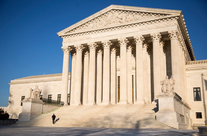 A police officer walks up the steps of the Supreme Court in Washington on March 2, 2015. (REUTERS/Joshua Roberts)